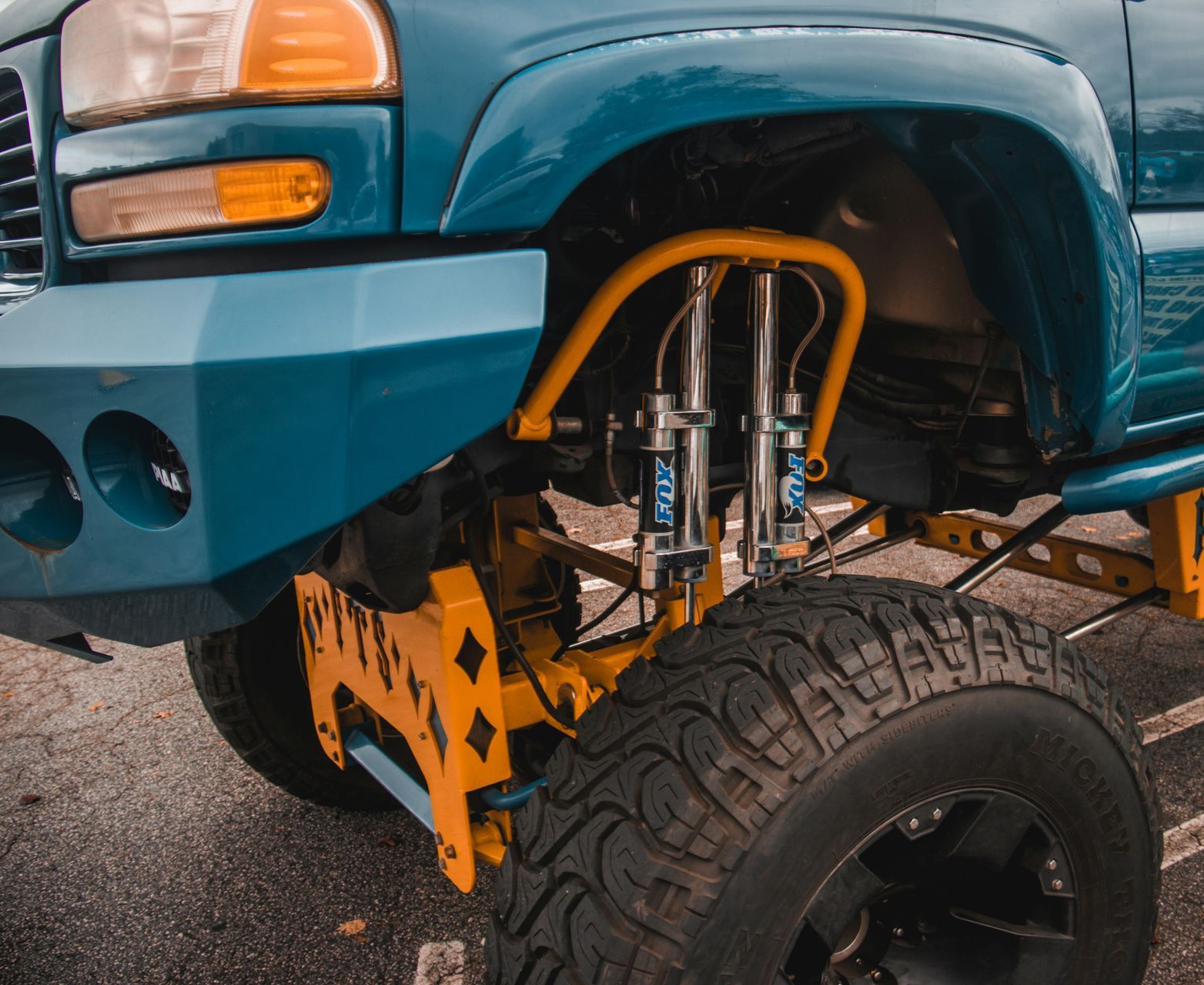 a person standing next to a blue truck